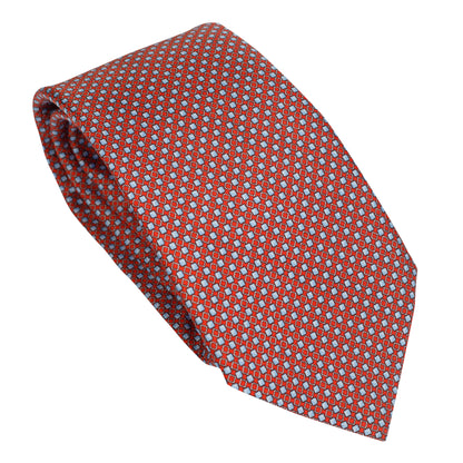 Cravatta in seta italiana al 100% rosso ruggine con motivo micro geometrico blu