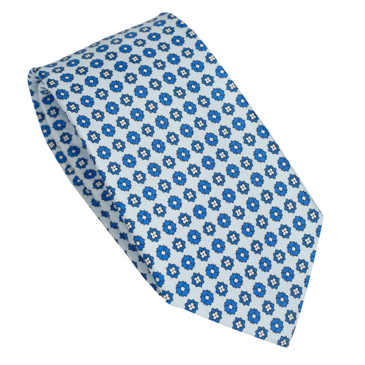 Cravatta in seta italiana al 100% celeste con motivo floreale micro blu